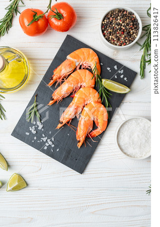 Fresh shrimps with lime and rosemary on white wooden table Fresh shrimps with lime and rosemary on white wooden table 113826417