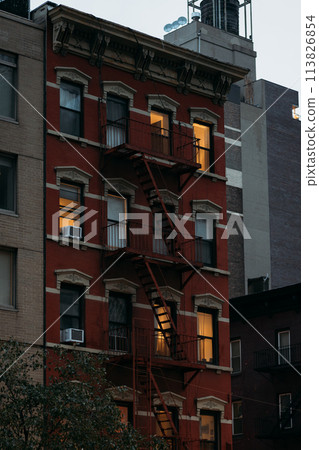 Warmly Lit Windows of a Red Brick New York Building at Dusk Warmly Lit Windows of a Red Brick New York Building at Dusk 113826854