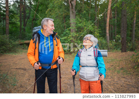 Hiking tourism adventure. Senior couple man woman enjoying outdoor recreation hiking in forest. Happy old people backpackers hikers enjoy walking hike trekking tourism active vacation beauty of nature 113827993