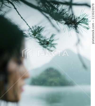 Blurry Photo of Woman Looking Over Lake 113828078