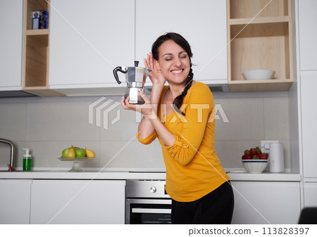 Happy Young woman showing moka pot 113828397