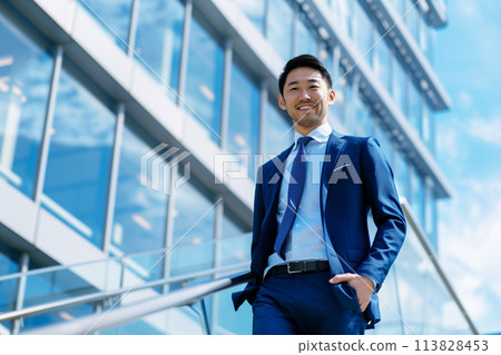 Male businessman walking in an office district 113828453