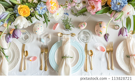 Easter table setting with painted eggs, spring flowers and crockery 113828721
