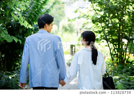 一對夫婦在清新的綠色公園散步的後視圖 113828739