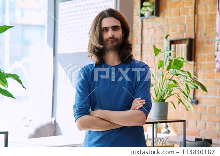 Portrait of young confident handsome man with crossed arms, looking at camera Portrait of young confident handsome man with crossed arms, looking at camera 113830187