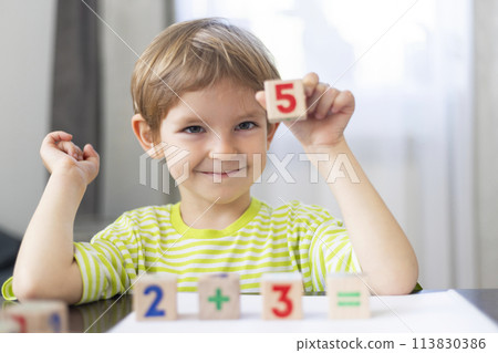 Boy Showing Number Five with Blocks 113830386