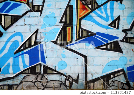 Colorful background of graffiti painting artwork with bright aerosol outlines on wall. Old school street art piece made with aerosol spray paint cans. Contemporary youth culture backdrop 113831427