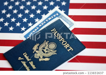 New Blue United States of America Passport and Social Security number on US Flag background. Concept of obtaining US citizenship New Blue United States of America Passport and Social Security number on US Flag background. Concept of obtaining US citizenship 113831637