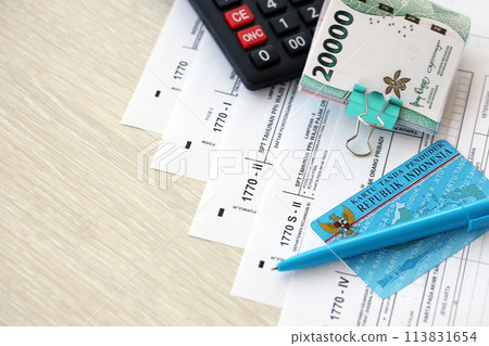 Annual Individual Income Tax Return forms with pen and indonesian rupiah bills. Original name is Surat Pemberitahuan Pajak or SPT Tahunan Annual Individual Income Tax Return forms with pen and indonesian rupiah bills. Original name is Surat Pemberitahuan Pajak or SPT Tahunan 113831654
