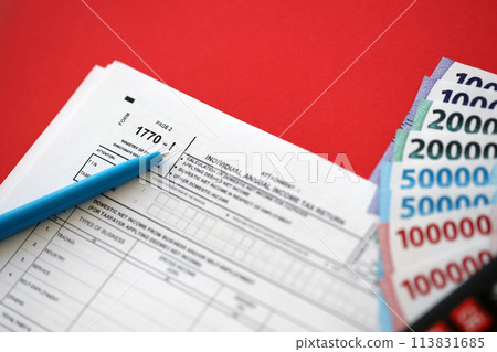 Indonesian tax form 1770-1 Individual Income Tax Return and pen on table close up 113831685
