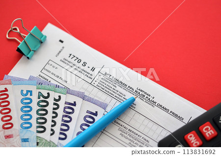 Indonesian tax form 1770 S - 2 Individual Income Tax Return and pen on table close up Indonesian tax form 1770 S - 2 Individual Income Tax Return and pen on table close up 113831692