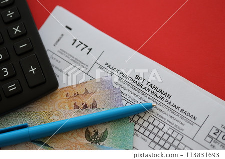 Indonesian tax form 1771 corporate taxpayers annual income tax return with pen lies on accountant table 113831693