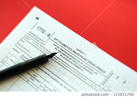 Indonesian tax form 1770-2 Individual Income Tax Return and pen on table close up 113831700