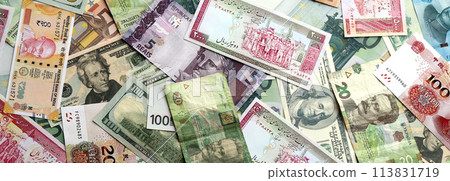 Many banknotes of different currency. Background of big amount of random money bills close up Many banknotes of different currency. Background of big amount of random money bills close up 113831719