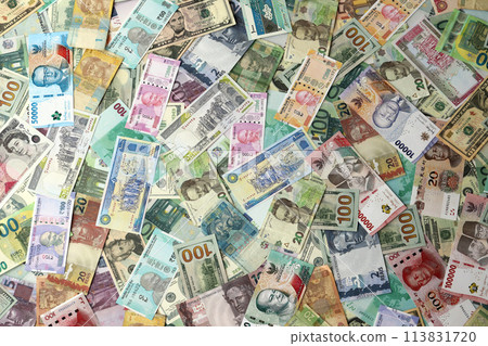 Many banknotes of different currency. Background of big amount of random money bills close up Many banknotes of different currency. Background of big amount of random money bills close up 113831720