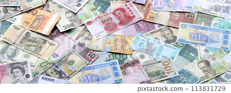 Many banknotes of different currency. Background of big amount of random money bills close up Many banknotes of different currency. Background of big amount of random money bills close up 113831729