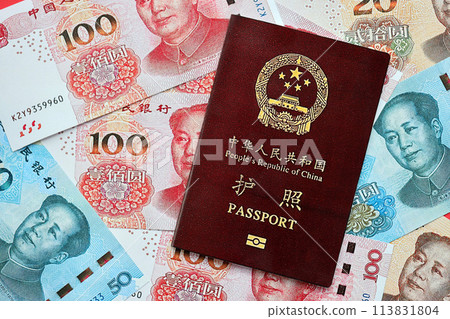Red passport of People Republic of China and chinese yuan money bills. PRC chinese passport on bright background close up Red passport of People Republic of China and chinese yuan money bills. PRC chinese passport on bright background close up 113831804