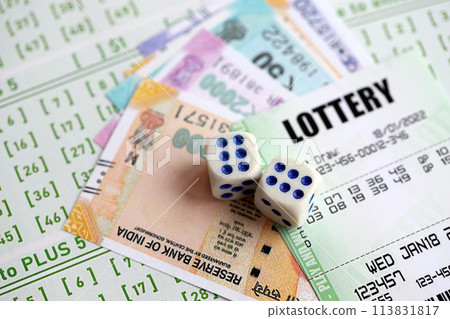 Green lottery tickets and indian rupees money bills on blank with numbers for playing lottery close up 113831817