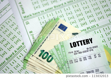 Green lottery tickets and euro money bills on blank with numbers for playing lottery close up 113832013