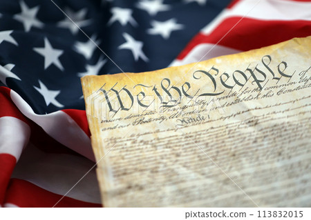Preamble to the Constitution of the United States and American Flag. Old yellow paper with We The People text 113832015