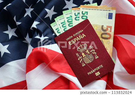 Red Spanish passport of European Union and money on United States national flag background close up. Tourism and diplomacy concept Red Spanish passport of European Union and money on United States national flag background close up. Tourism and diplomacy concept 113832024