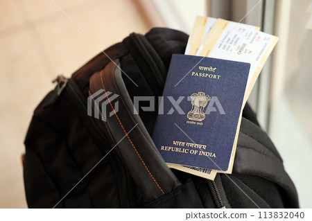 Blue Indian passport with airline tickets on touristic backpack close up. Tourism and travel concept 113832040