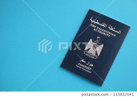 Blue Palestinian Authority passport on blue background close up. Tourism and citizenship concept Blue Palestinian Authority passport on blue background close up. Tourism and citizenship concept 113832041
