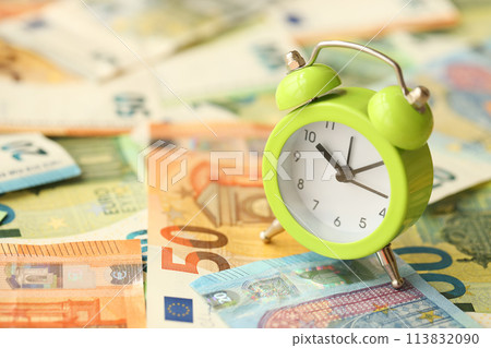 Many European euro money bills and alarm clock. Lot of banknotes of European union currency close up Many European euro money bills and alarm clock. Lot of banknotes of European union currency close up 113832090