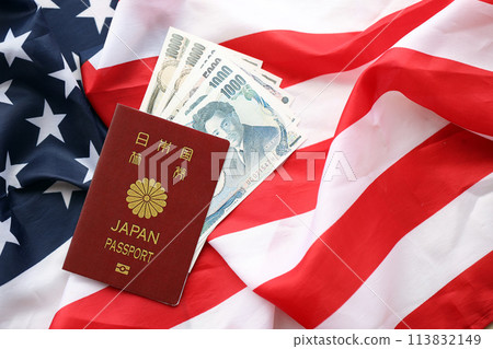 Japan passport with japanese yen money bills on United States flag close up Japan passport with japanese yen money bills on United States flag close up 113832149