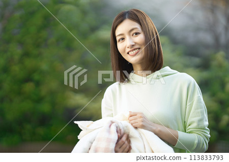 middle-aged woman with laundry middle-aged woman with laundry 113833793