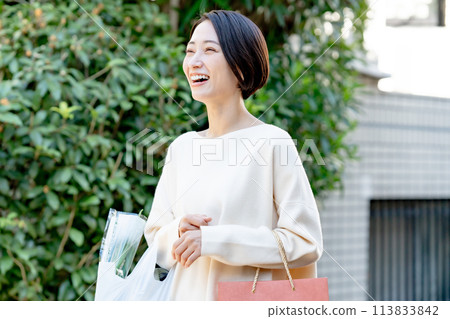 A woman with a shopping bag A woman with a shopping bag 113833842