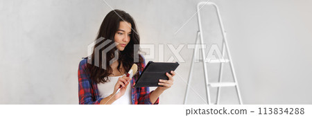 Renovation Ideas From Internet During Room Repair by Asian Casual Girl 113834288