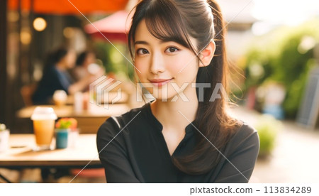 Smiling woman on a cafe terrace 113834289