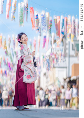 A young woman in hakama walking along Taisho Roman Street A young woman in hakama walking along Taisho Roman Street 113835215