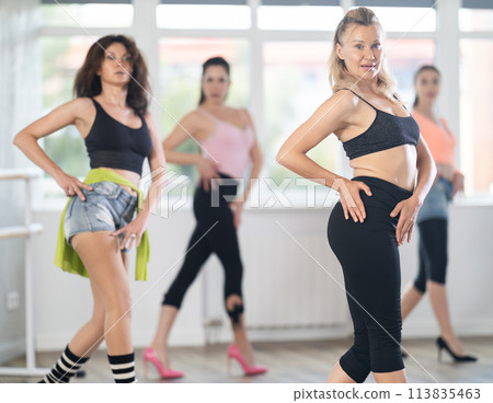 Female dancer practicing jazz-funk dance moves in high heels in studio 113835463