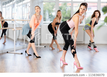 Adult woman dancing high heels in group Adult woman dancing high heels in group 113836070