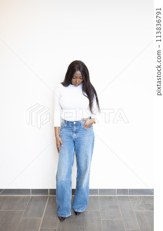 Stylish Woman in White Turtleneck and Wide-Leg Jeans Stylish Woman in White Turtleneck and Wide-Leg Jeans 113836791