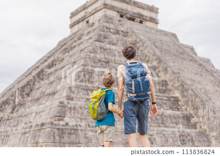 Father and son tourists observing the old pyramid and temple of the castle of the Mayan architecture known as Chichen Itza these are the ruins of this ancient pre-columbian civilization and part of Father and son tourists observing the old pyramid and temple of the castle of the Mayan architecture known as Chichen Itza these are the ruins of this ancient pre-columbian civilization and part of 113836824