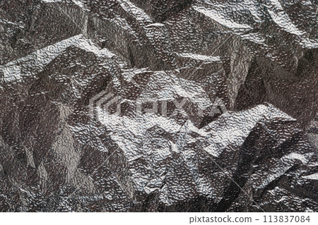 Silver crumpled foil textural background 113837084