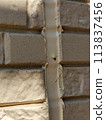 Replacing poorly applied caulking during exterior wall painting [holes present] 113837456