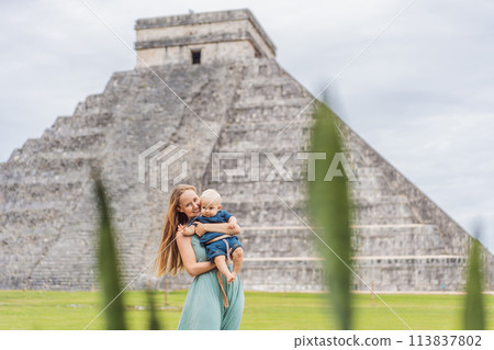 Beautiful tourist woman and her son baby observing the old pyramid and temple of the castle of the Mayan architecture known as Chichen Itza these are the ruins of this ancient pre-columbian Beautiful tourist woman and her son baby observing the old pyramid and temple of the castle of the Mayan architecture known as Chichen Itza these are the ruins of this ancient pre-columbian 113837802