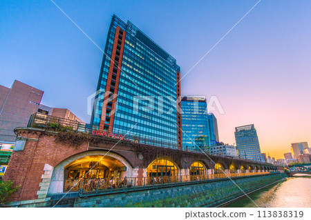 Tokyo cityscape in Japan - View of Marche Ecute and Kanda River from Manseibashi Bridge - night view (towards Ochanomizu Station in the back right) 113838319