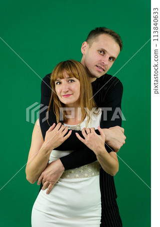 Young attractive business people in formal, black and white clothes. On a green background. High quality photo 113840633