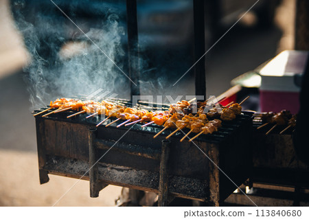 Meat on skewers grilled at street food Meat on skewers grilled at street food 113840680
