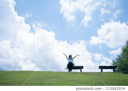 solo woman happy and enjoy with summer travel with cloudy background solo woman happy and enjoy with summer travel with cloudy background 113842034