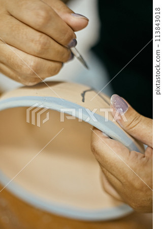 Close up potter painting 113843018