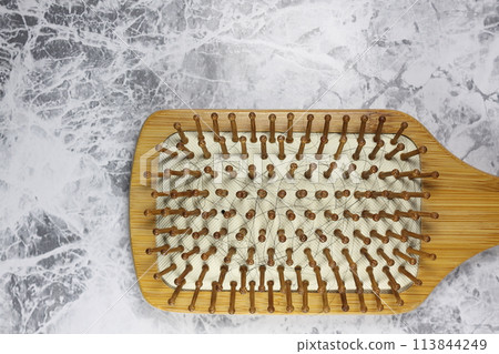 Hair tangled in a hairbrush Hair tangled in a hairbrush 113844249
