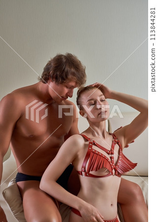 Seductive couple in leather underwear in studio 113844281