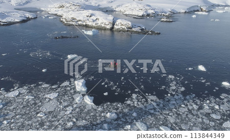 Zodiac Boat Sail Brash Ice Water Tracking Pan. Drone Flight Above Transport Rubber Boat Float in Extreme Winter Open Water. South Pole Ocean Landscape Zodiac Boat Sail Brash Ice Water Tracking Pan. Drone Flight Above Transport Rubber Boat Float in Extreme Winter Open Water. South Pole Ocean Landscape 113844349