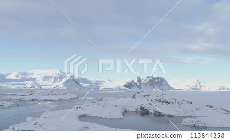 Drone Flight Over Antarctic Science Station - Academician Vernadsky. View of Snow Coast, Ocean, Water Surface. South Pole Settlement Base Majestic Landscape. Aerial Slow Speed Flight 113844358